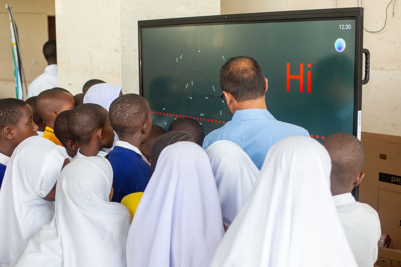 Students gathered around an interactive smart screen