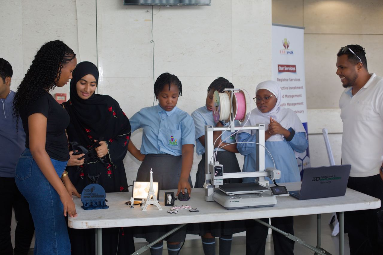 Students demonstrating 3D printing and engineering at the exhibition