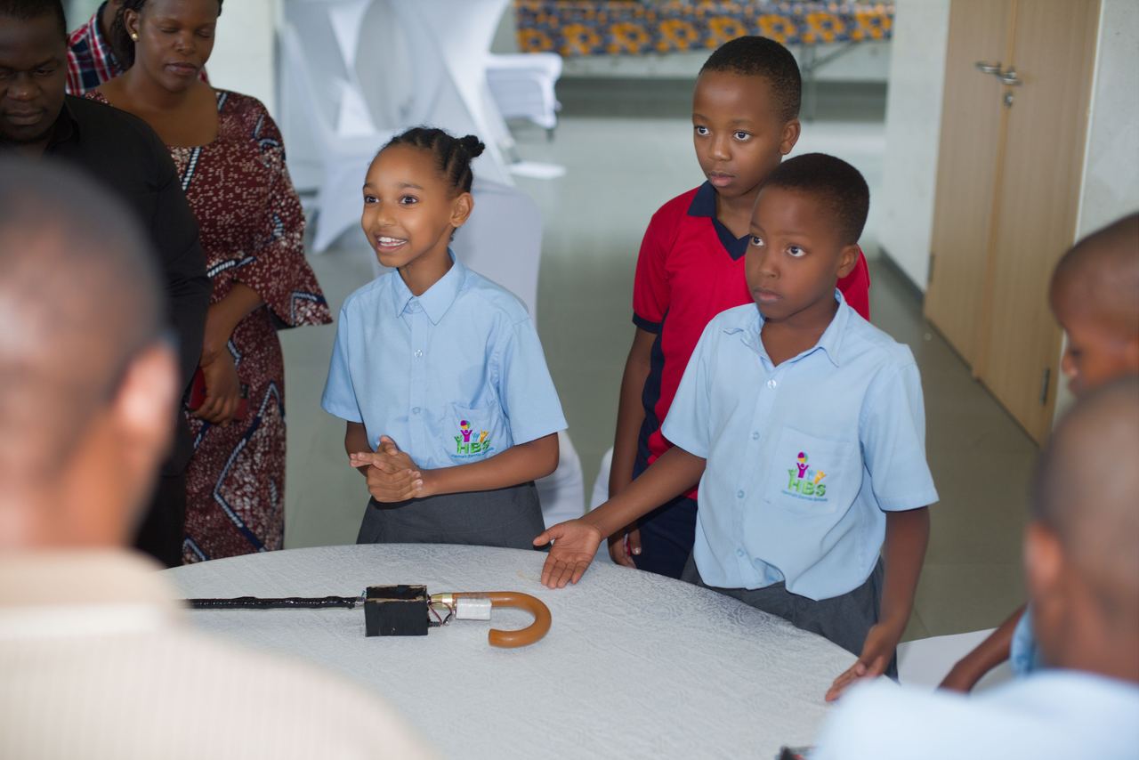 Students presenting a walking-stick technology invention