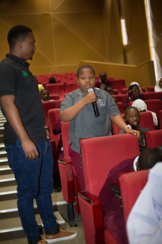 A student speaking into a microphone during the programme